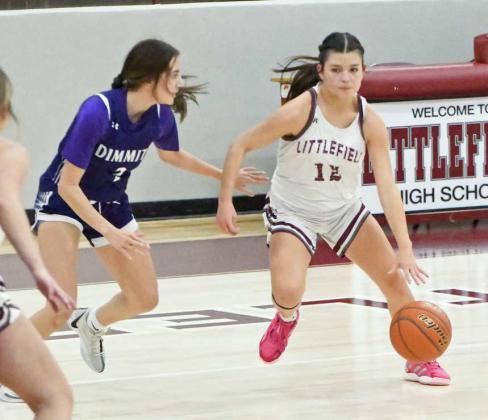 Littlefield’s Cali Saldana puts the ball on the floor as she looks for a lane to the basket, during the first half of their contest against Dimmitt on Tuesday at Wildcat Gym. (Staff Photo by Derek Lopez)