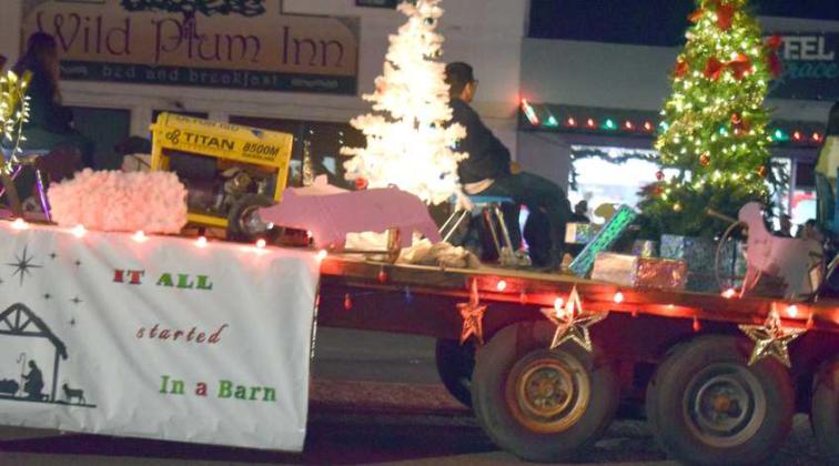 IN WEST TEXAS FASHION this Christmas float declares ‘It Started in A Barn” during the Olton Hometown Christmas parade. (Photo by Ann Reagan)