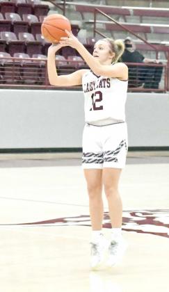 SHOWING THE RANGE —Littlefield sophomore, Madison McNeese (12), dribbles up to the top of the key and buries a three to get the Lady Cats on the board Tuesday night, during their contest against Hereford. (Staff Photo by Derek Lopez)