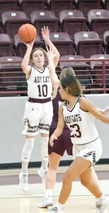 CORNER SHOOTING -Littlefield junior, Brookelyn Gau (10), fires up a three from the right wing off of the assist from senior, Geyah Garza (23), during the first half of the Lady Cats’, 52-40, loss to the Lady Whitefaces on Tuesday at Wildcat Gym. (Staff Photo by Derek Lopez)