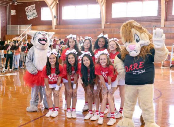 Junior High Cheerleaders and Mascot pose with the D.A.R.E Lion for Red Ribbon Week. (Photo by Ann Reagan)