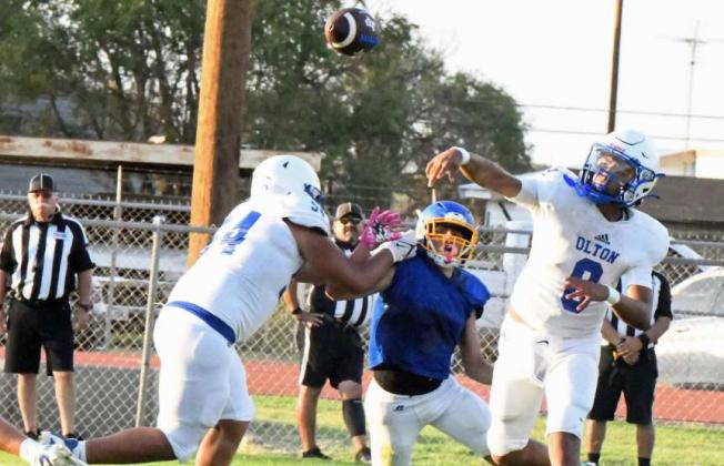 Olton quarterback Raymond Ramirez fires a dart to his left looking for a receiver in the endzone on the goal line, during the Mustangs’ scrimmage with the Owls on Thursday at Owl Stadium. (Staff Photo by Derek Lopez)
