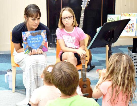 MS TONI MEREDITH takes a question from a child at the Lamb County Library reading Program on June 14th, 2023. She used a variety of musical instruments to illustrate that different does not always mean the thing or person is bad, so we should always be kind. (Photo by Ann Reagan)