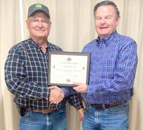 LARRY HOBRATSCHK, left, recently received a certificate of recognition for his 25 years of dedication and service to the Lamb County Soil and Water Conservation District (SWCD), from Jack Foote, right, Field Representative, Area 1, Texas Soil &amp;amp; Water Conservation Board. Hobratschk, who has represented the local district since 1996, is currently serving as a member, and secretary of the Lamb County SWCD. (Submitted Photo)