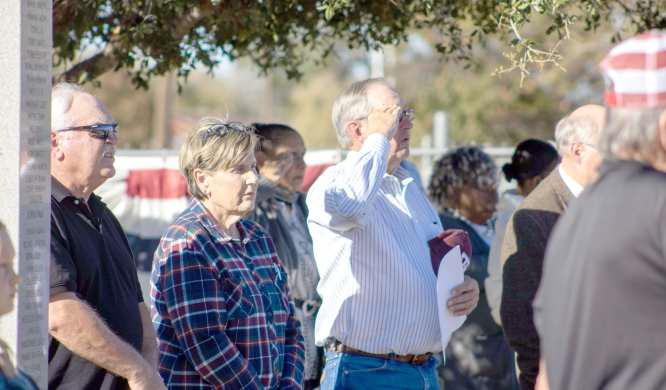 Veterans and family members salute the flag during the national anthem at the event honoring Littlefield veterans on Nov. 10, 2024. (Staff Photo by Madison Vidales)