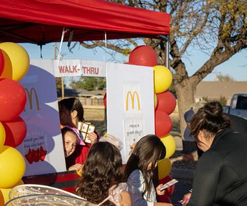 Simulating a McDonald’s drive-thru, children pass out candy to Lamb Healthcare Center’s Trunk or Treat attendees on Oct. 31. (Staff Photo by Madison Vidales)