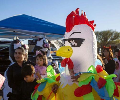A child wearing an inflatable chicken waits for treats at the Lamb Healthcare Center’s Trunk or Treat on Oct. 31. (Staff Photo by Madison Vidales)
