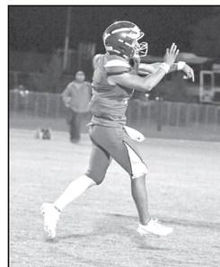 Springlake-Earth’s Froylan Agundiz connects with Kaylob Frietz for a touchdown, during the Wolverine’s Homecoming victory over Petersburg on Friday night. (Staff Photo by Derek Lopez)