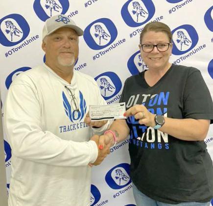 Pictured is Olton Athletic Director, Ross Lassiter accepting the donation from OABC Treasurer, Tori Clayton. (Submitted Photo)