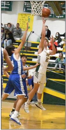POINTS IN THE PAINT — Springlake-Earth sophomore, Braxton Ethridge (11), drops in a layup for the Wolverines, during the second half of their home loss to the Olton Mustangs last week at Wolverine Gym. (Staff Photo by Derek Lopez)