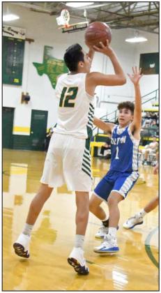 LETTING THE THREE FLY—Springlake-Earth junior, Kaden Castillo (12), fires up a three from the right elbow over the Olton defense, during the second half of their home loss to the Olton Mustangs last week at Wolverine Gym. (Staff Photo by Derek Lopez)