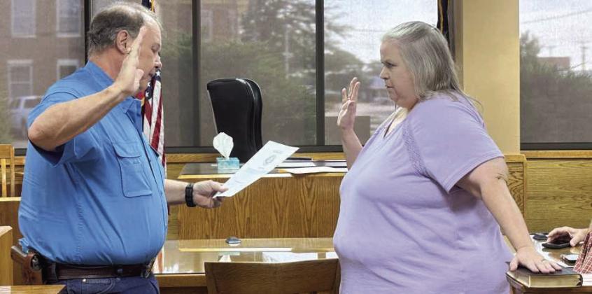 Lamb County Judge James DeLoach administers the Oath of Office to newly appointed Precinct 1 Justice of the Peace, Teresa Perez, during a special Commissioners Court Meeting held on July 1st, at the Lamb County Courthouse. (Photo by Madison Vidales)