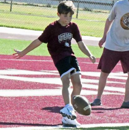 Campers at the 2025 Littlefield Youth Football Camp worked on kicking off of a tee, during the second day of camp on Tuesday. (Staff Photo by Derek Lopez)
