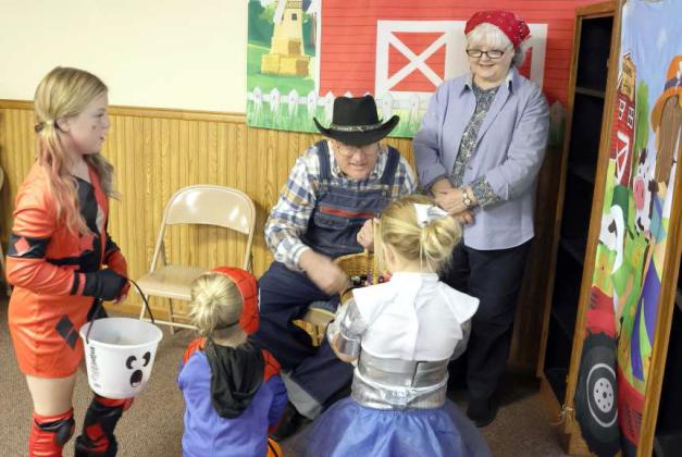 Farmer Jim and LeLani Harris greet trick or treaters at the Crescent Park Church of Christ Trunk or Treat on Sunday, October 29, 2023. (Photo byAnn Reagan)