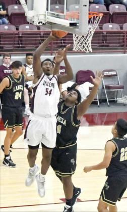 GOING UP STRONG—Littlefield senior forward, Tyree Jones (54), goes up strong to the basket for a lay-up on the right side over Lamesa’s Sean Zapata (54), during the second half of the Wildcats victory over the Golden Tornadoes in their district-opener on Friday. (Staff Photo by Derek Lopez)