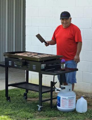 Members of the Littlefield Booster Club and United Supermarkets helped prepare burgers and hot dogs that were donated by United Supermarkets in Littlefield for the football team and coaches, after the Intersquad scrimmage on Saturday at Wildcat Stadium. (Staff Photo by Derek Lopez)