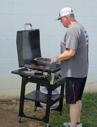 Members of the Littlefield Booster Club and United Supermarkets helped prepare burgers and hot dogs that were donated by United Supermarkets in Littlefield for the football team and coaches, after the Intersquad scrimmage on Saturday at Wildcat Stadium. (Staff Photo by Derek Lopez)