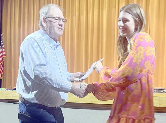 First Place recipient of the Lamb County SWCD scholarship, Kyndal Edwards, was awarded at the Sudan Award assembly held at Sudan High School on Tuesday May 16, 2023. Shown is Edwards receiving the $500 Scholarship from Roy Thompson. (Submitted Photo)