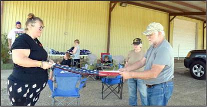 Members of the Guardians of Old GloryM fold the US Flag during the flag retirement event held at the Lamb County Ag Center on Saturday, September 9,2023. (Photo by Ann Reagan)