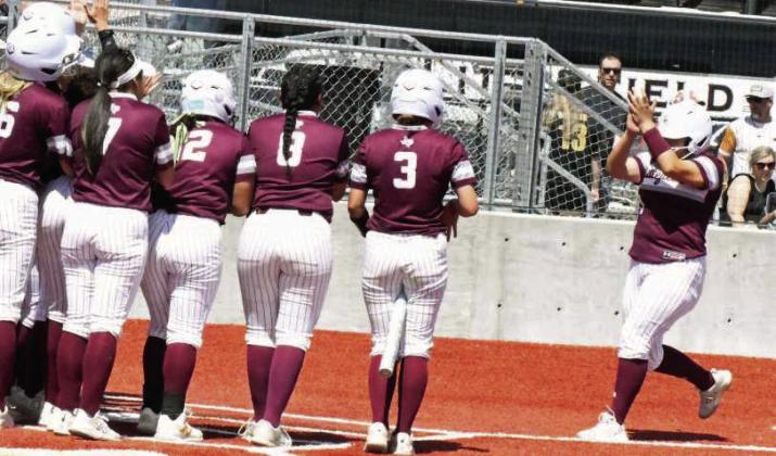 Littlefield’s Brianna Aleman is met at home plate by her teammates, after blasting a three-run homerun to right-center field, during the top of the first inning of game two of the Lady Cat’s Bi-district series last Saturday at Bushland. (Staff Photo by Derek Lopez)