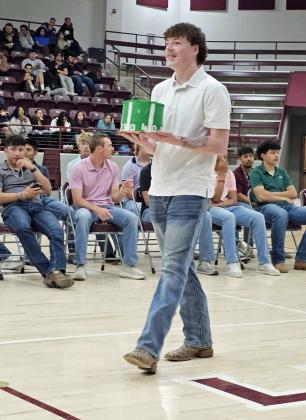 Jacob Silvas shows off his cake during the 2025 LHS Cake Auction on Wednesday. (Staff Photo by Derek Lopez)