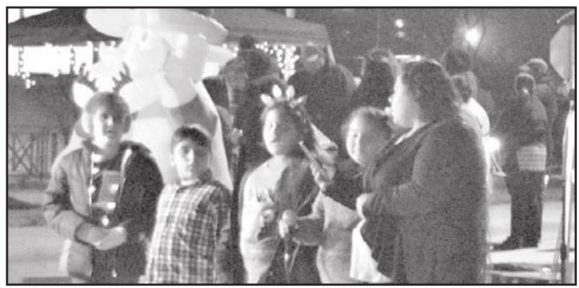 Members of the Temple of Adoration Children’s Choir performed Christmas songs at “Holiday on the Square” downtown Littlefield on Thursday, Dec. 16, 2021. (Photo by Ann Reagan)