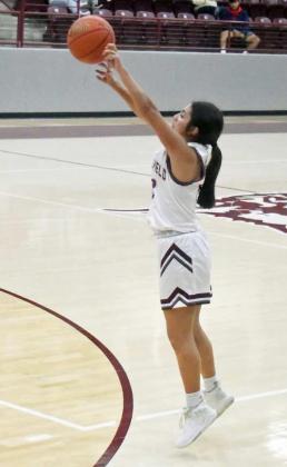 FIRING THE THREE – Littlefield’s Arianna Cruz gets puts up a three from the left elbow, during the first half of the Lady Cats’ victory over Olton in their Wildcat Classic Tournament-opener on Monday night. (Staff Photo by Derek Lopez)