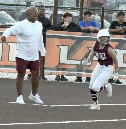 Littlefield junior, Alyssa Torres gets waived around third by Head Coach Keith Logan, as she looks to score on a double off of the right field fence by Natalia Sanchez in the bottom of the sixth inning of the Lady Cats, 9- 3, loss to the Presidio Lady Devils in the Class 3A Bi-district round of the Play-offs in Wink. ( Staff Photo by Derek Lopez)