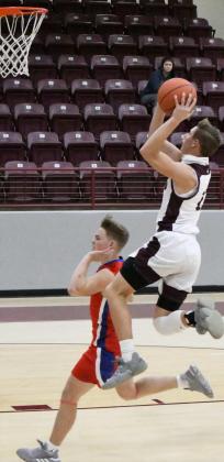 FINISHINGTHE BREAK—Littlefield junior, Ethan Garcia (22), goes up strong to the basket, avoiding the contact to finish off the fast break, during the first half of the Wildcats’ victory over the Roughnecks on Tuesday. (Staff Photo by Derek Lopez)