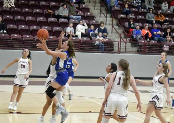 Olton’s Kylee Noack (12) takes the ball strong to the hoop against the Littlefield Lady Cats in the Wildcat Classic. (Staff Photo by Derek Lopez)