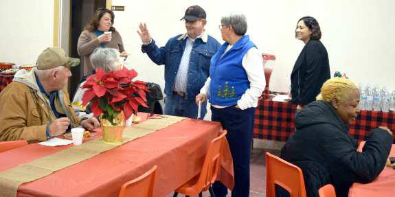 Amherst residents enjoying good food and conversation at the Amherst WednesdayCity Hall during the Christmas Open House held Wednesday, December 14, 2022. (Photo by Ann Reagan)