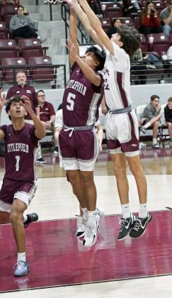 Littlefield senior, Caden Reyes (5), fights for a rebound, during the first half of the Wildcats’ road victory over the Roosevelt Eagles on Friday. (Staff Photo by Derek Lopez)