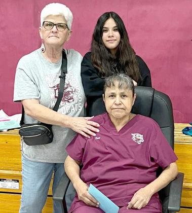 Peggy Robison, left, renames “Coins for Kids” fundraiser to “Terri’s Treasures” this year. The funds raised by the Primary Students went to Terri Contreras, seated, to help with her cancer treatments. Terri’s granddaughter is shown behind her. (Submitted Photo)