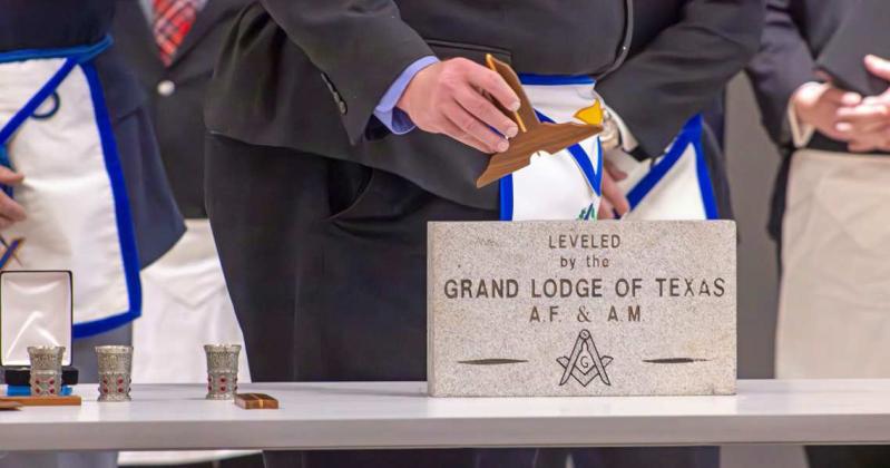 District Instructor Tim Smith applied the Level he stone at the Cornerstone Leveling Ceremony at Littlefield High School on Dec. 7, 2024. (Staff Photo Rhode Duenas)