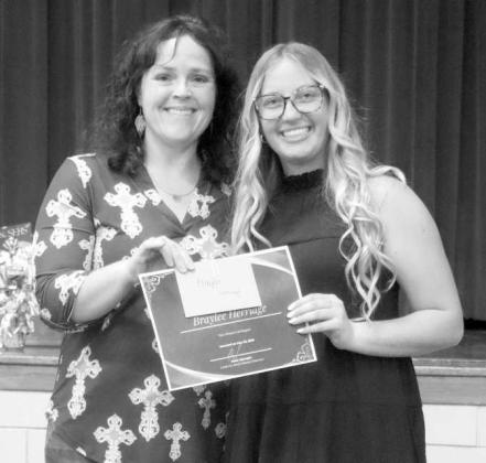 Lamb County NRCS District Conservationist Brenda May awards Springlake-Earth High School’s Senior Essay Contest first-place winner, Braylee Herriage, with a certificate and a $100 prize. (Submitted Photo)