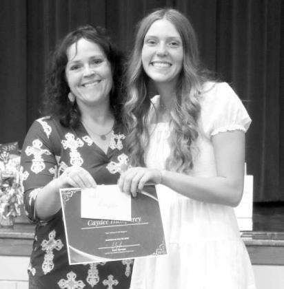 Lamb County NRCS District Conservationist Brenda May awards Springlake-Earth High School’s Senior Essay Contest third-place winner Caydee Humphrey, with a certificate and a $50 prize. (Submitted Photo)