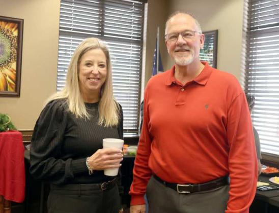 Stacey Morris-Potter-COO of First United Bank and Lance Broadhurst of the First United Bank of Littlefield, Texas, enjoyed the buffet at the Christmas Open House held on Friday, December 13, 2024. (Photo by Ann Reagan)