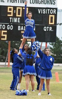 SCHOOL SPIRIT – The Amherst Cheerleaders perform the school song prior to the start of the Bulldog’s district-opener on Thursday at Lazbuddie. The Bulldogs won the game on the first drive of the third quarter, 58-8, forcing the 45-point mercy rule to go into effect. (Staff Photo by Derek Lopez)