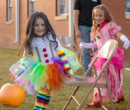 Children dressed as a clown and Princess Peach play musical chairs at the Crescent Park Church of Christ’s Trunk or Treat on Oct. 27, 2024. (Staff Photo by Madison Vidales)