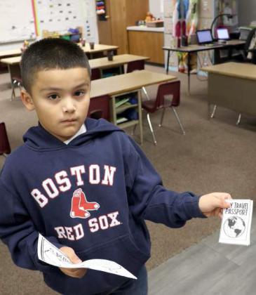 This young man just had his passport stamped during the Christmas around the World Family night on Monday, December 11, 2023. (Photo by Ann Reagan)