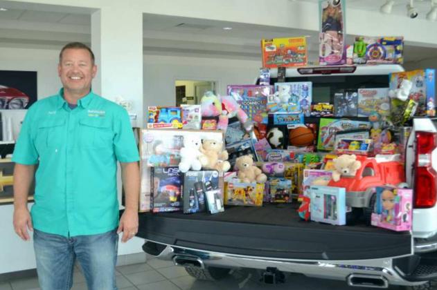 MORE TOYS NEEDED -- Jeff Shelley at John Roley’s AutoCenter needs help to completely fill the truck with toys so that all the boys and girls in Lamb County can have a great Christmas. Donations need to be made by Friday, Dec. 17th. (Photo by Grata Reber)