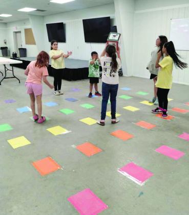 During the Lamb County Library’s Summer Reading Program closing celebration on July 1, attending children participate in Dino-lympics games. (Photo by Leon Szaniszlo)