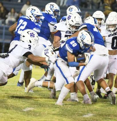 Olton running back, Callen Burns, shakes off a would-be tackler as he breaks through the line for a solid gain, during the second half of the Mustangs, 33-14, victory over the Dimmitt Bobcats on Friday at Mustangs Stadium. (Staff Photo by Derek Lopez)