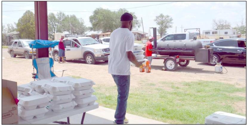 FOOD TRAYS consisting of hamburgers, chips and pound cake were delivered to shut-ins and drive-thru pick-up at Dunbar Park during the annual Juneteenth Celebration. (Staff Photo by Samantha Pontius)