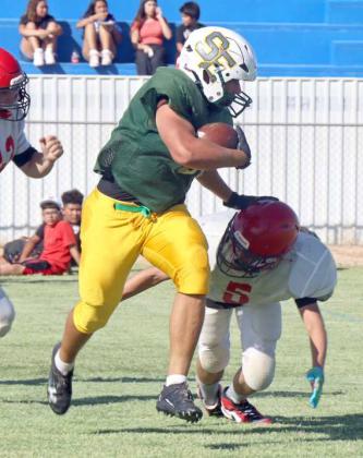 The Springlake-Earth ball carrier stiff arms a defender, during their first scrimmage of the season at Amherst. (Photo Courtesy of Sarah Weldon)