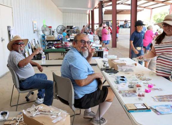 These two members of the Sacred Heart Catholic Church of Littlefield are working hard or hardly working at a booth during the Jamaica Day Celebration event held on Sunday, August 25, 2024. Either way, they reflect the happy mood of the event. (Photo by Ann Reagan)