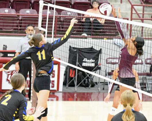 Littlefield freshman, London Taylor, deliveres a block on Wellman-Union’s, Ansley Brown, during the Lady Cat’s season-opener on Tuesday at Wildcat Gym. The Lady Cats took the match, 2-1. (Staff Photo by Derek Lopez)