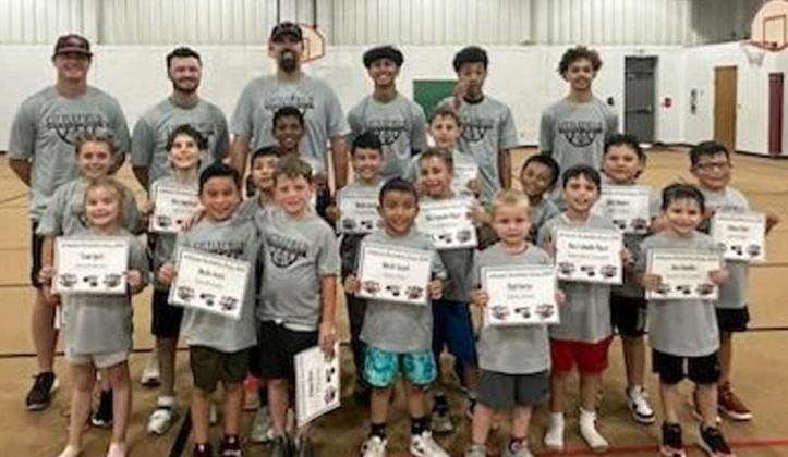 The 2024 Littlefield Youth Wildcat Basketball Camp concluded last Thursday. Shown is Head Coach Nathan McKinnon, Asst. Coach Nathan Hobbs, Asst. Coach Blake Green and current Wildcat Basketball Players, Jayden Barrio, Kam McCarty and Ryan Williams with the morning session of the camp. (Submitted Photo)