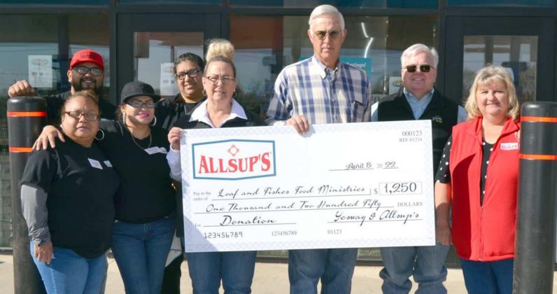 $1,250 CHECK TO BENEFIT SUDAN COMMUNITY– During the Grand Opening of Sudan’s Allsup’s Market Friday morning, this oversized check was donated by Yesway and Allsup’s to the City of Sudan’s “Loaf and Fishes Food Ministries”. Holding the check are Sherri Bear, store manager; and Kenn Carr, Sudan banker. (Staff Photo by Joella Lovvorn)