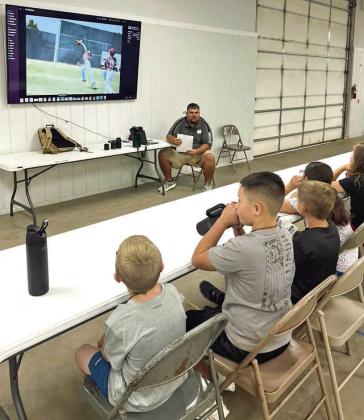 Campers at the 4-H Project Camp are shown learning about photography from Lamb County Leader-News Sports Editor Derek Lopez, during day two of Project Camp on Tuesday at the Lamb County Ag Center. (Submitted Photo)